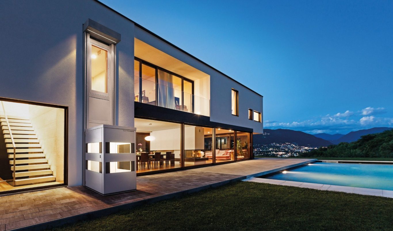 Modernes Haus mit großen Fenstern, Pool und stilvoller Terrasse bei Dämmerung in Münster Modernes Haus mit großen Fenstern, Pool und stilvoller Terrasse bei Dämmerung in Münster